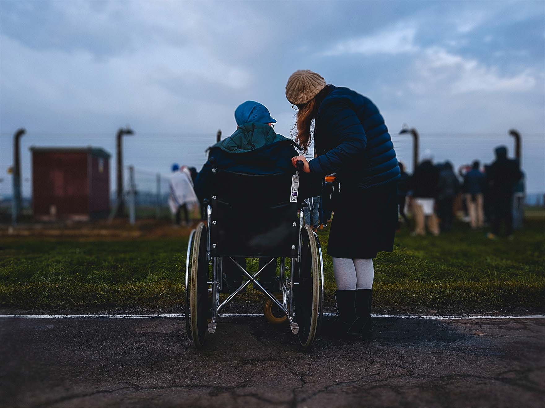resident in a wheelchair and carer outside