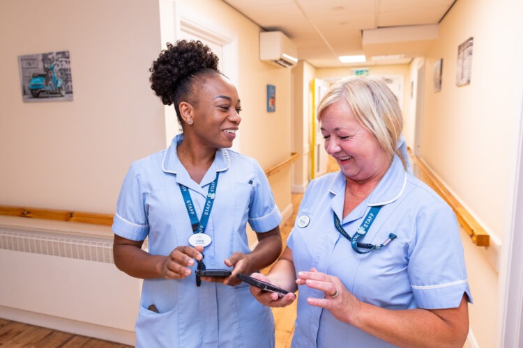 carers in the hallway looking at care plans