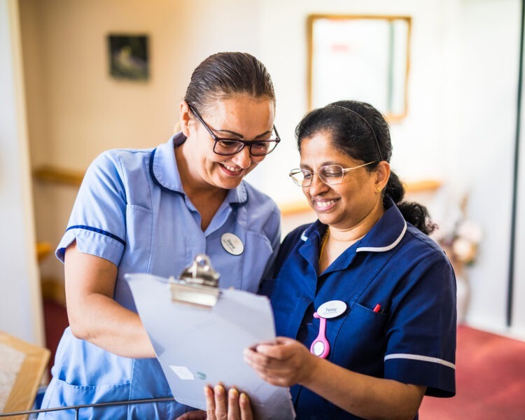 nurse and a carer looking at care plan