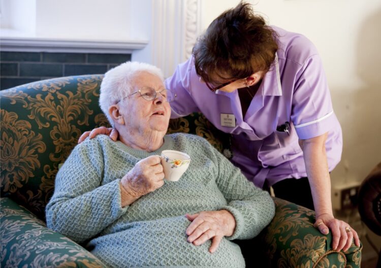 resident having a cup of tea with carer