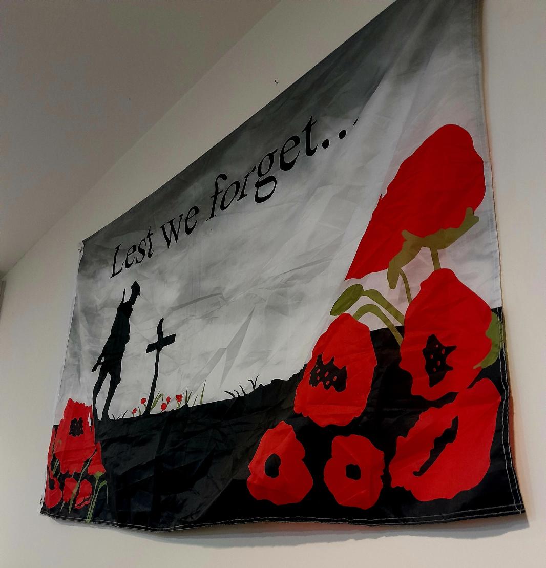 lest we forget flag on the wall
